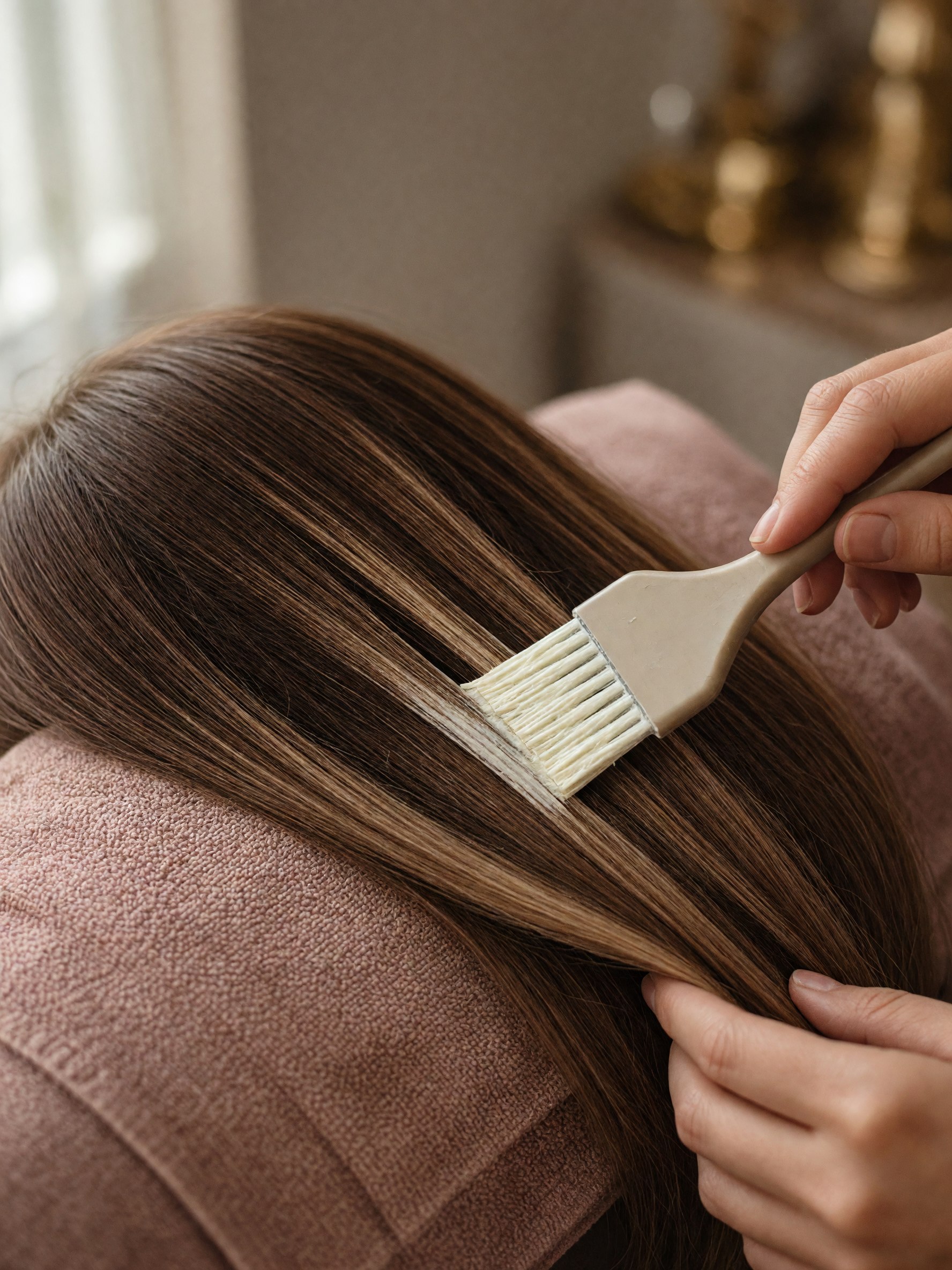 Honey-brown hair with a warmer ribbon of color through the lengths.